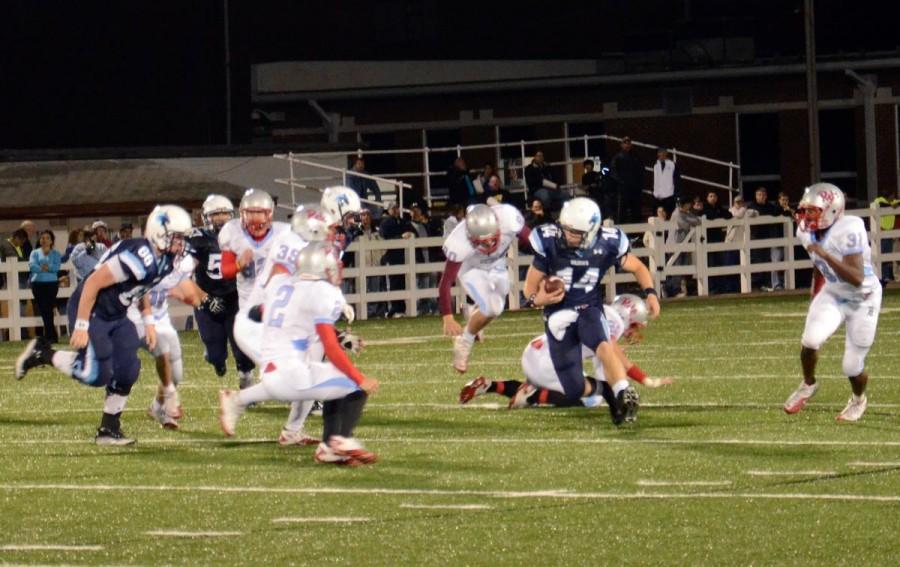 Senior quarterback Jon Vaughn carries the ball for extra yardage against a tough Southside defense. The Wildcats suffered their first conference loss to the Rebels Oct. 21. Photo by Sara Lachance