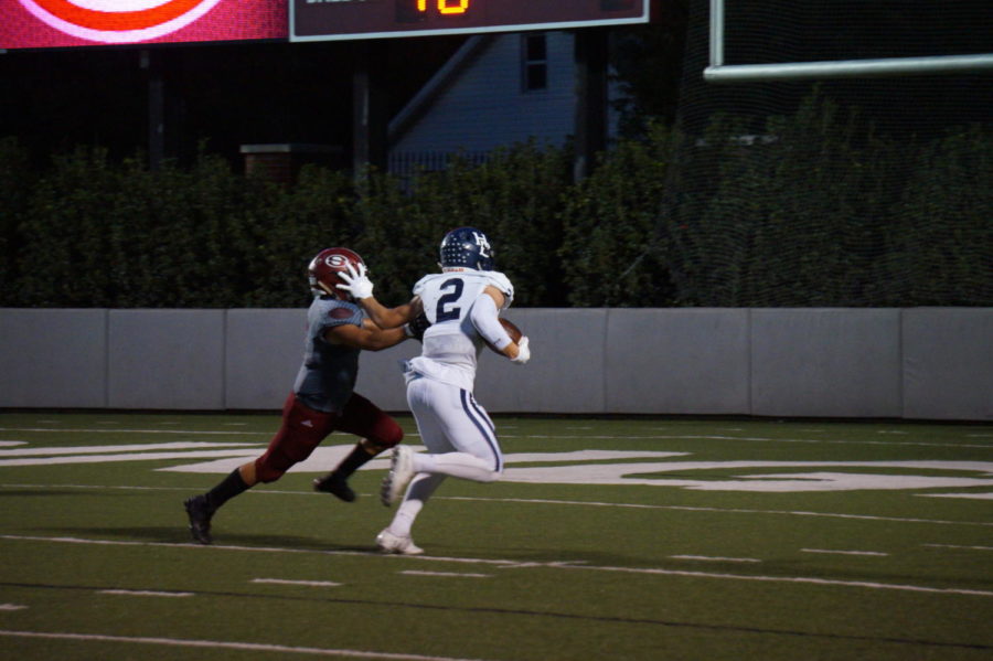 Junior receiver Hunter Wood stiff arms a Bulldog defender to score a touchdown Oct. 5.