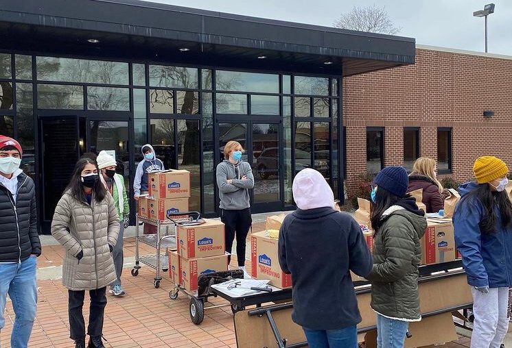 Arkansas United Youth Committee distributes food drive items outside St. Raphaels Catholic Church.