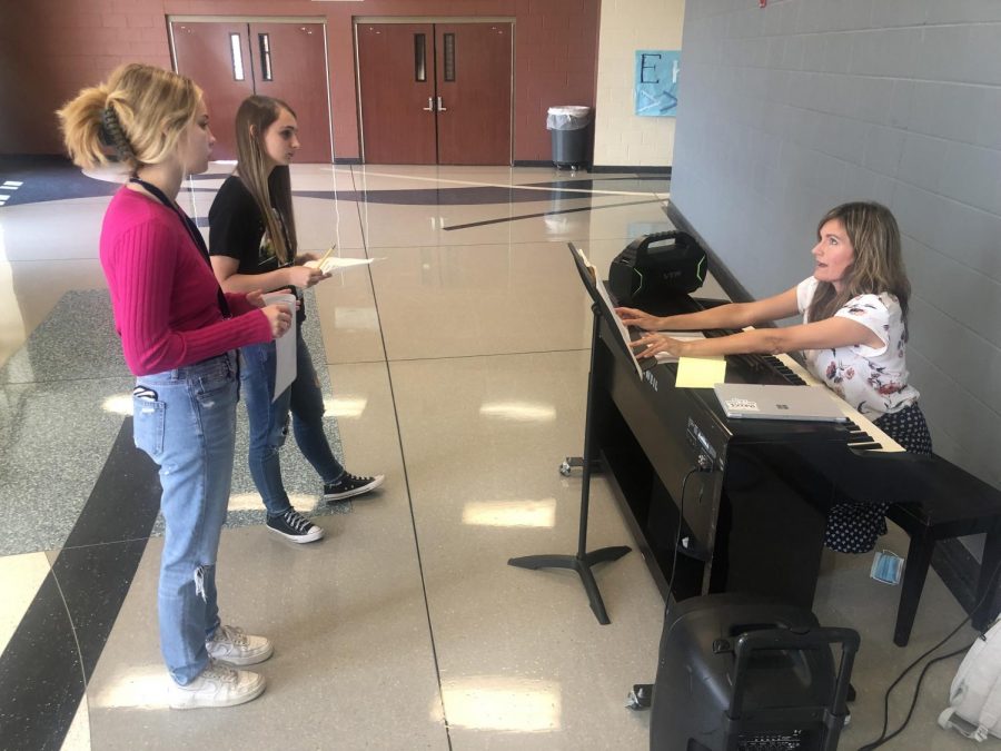Choir members practice in the hallway outside the choir room to prepare for All Region tryouts. 
