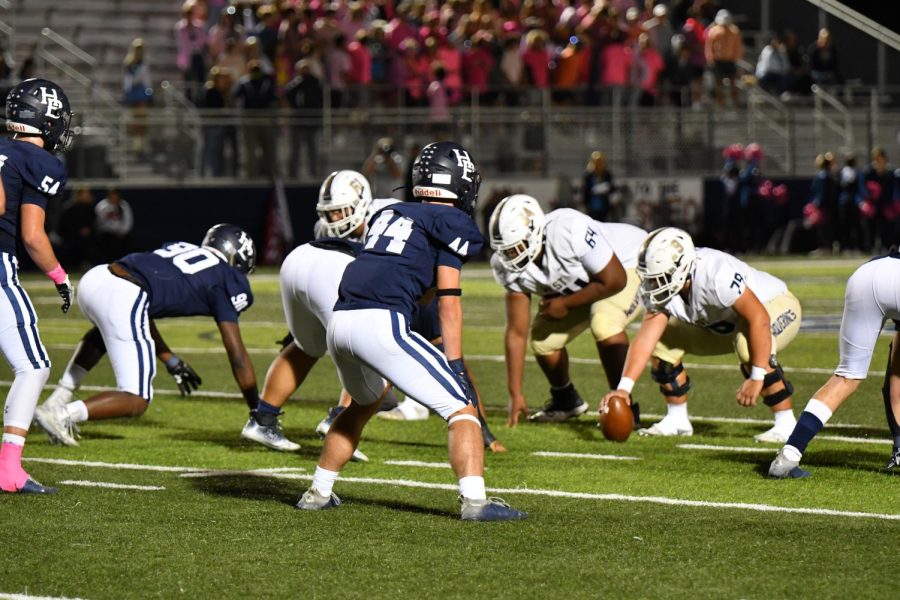 Senior outside linebacker Chris McGehee signals to his teammates on defense against Heritage on Sept. 30