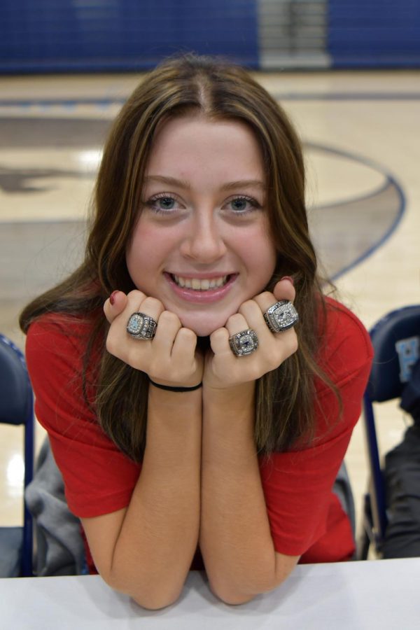 Senior Lauren Milligan shows off her three state championship rings during her signing of her national letter of intent. 