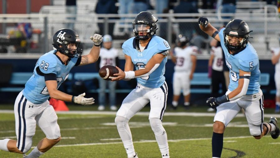 Senior quarterback Luke Buchanan hands the ball of to senior running back Hudson Brewer.
