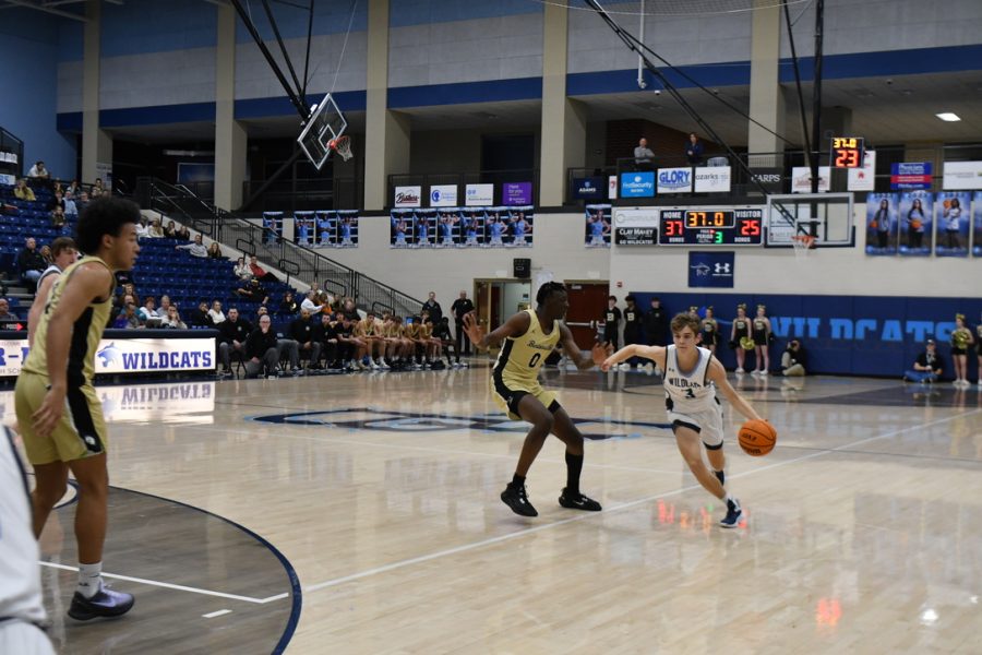 Senior point guard Jake Myers drives down the court against a Bentonville Tiger in a conference game at Wildcat Arena on Jan. 6.