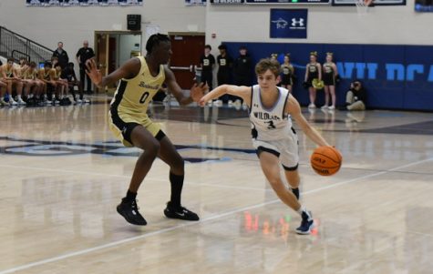 Senior point guard Jake Myers drives down the court against a Bentonville Tiger in a conference game at Wildcat Arena on Jan. 6. 
