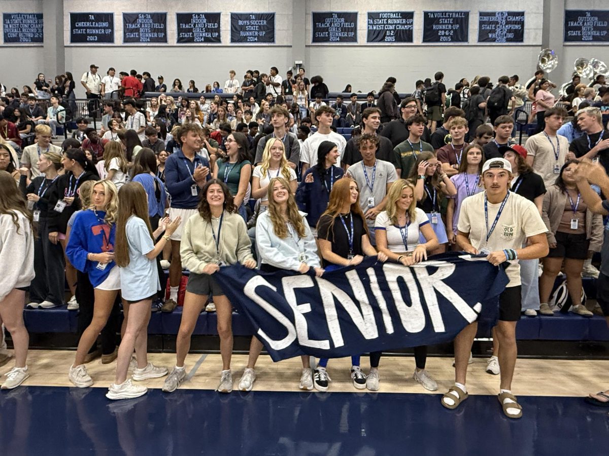 Members of the senior class sway along to the music during the Aug. 22 pep rally in Wildcat Arena. 