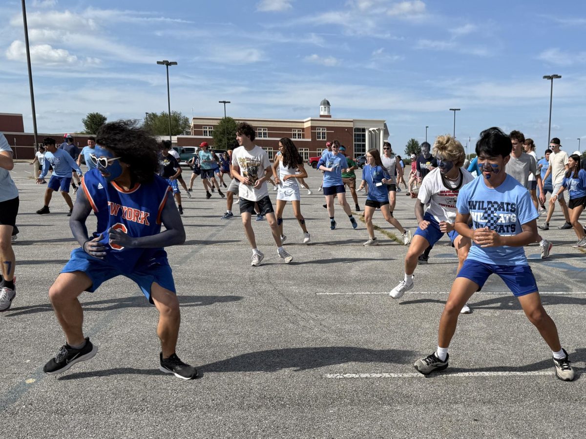 Band students warm up in the south parking lot prior to marching practice. Students dressed up for spirit week. 