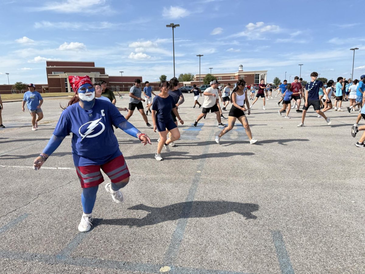 Band students warm up in the south parking lot prior to marching practice. Students dressed up for spirit week. 
