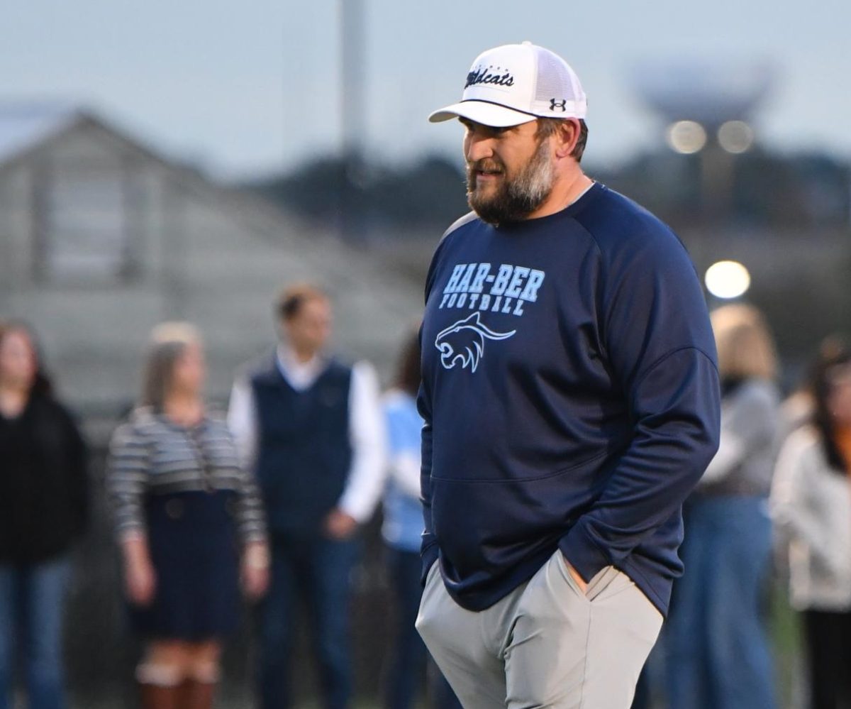 Football head coach Aaron Danenhauer walks across midfield during pregame ceremonies at Wildcat Stadium on Aug. 29. After serving at Bentonville High School for the past 13 years, he becomes the third head coach in 21 years. 